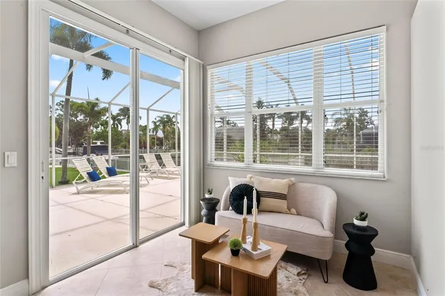 an empty room with windows and ceiling fan