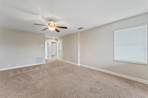 a view of a house with a yard and potted plants