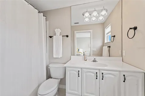 a view of house with swimming pool and outdoor seating