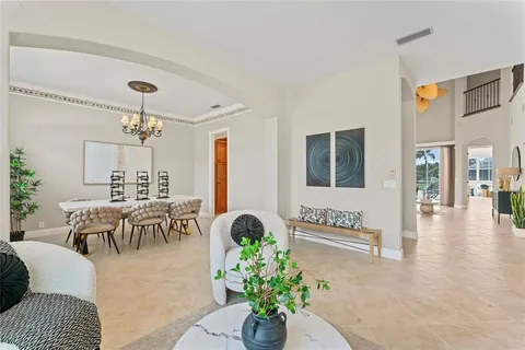 a living room with furniture and floor to ceiling windows