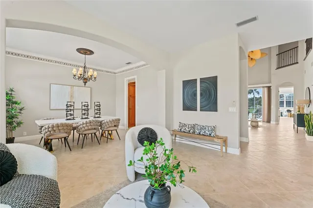 a living room with furniture and floor to ceiling windows