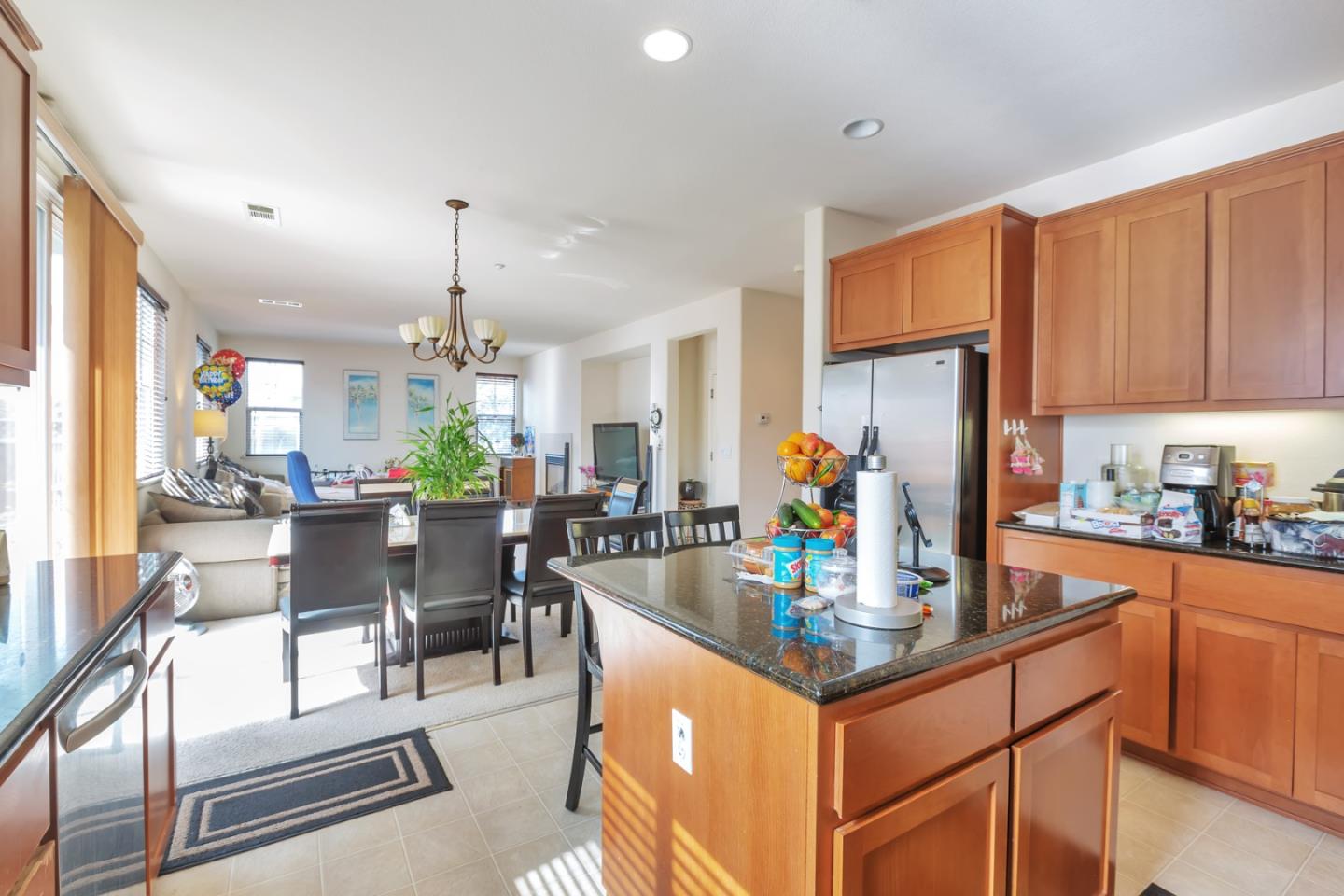 22860 Mono Street Hayward, CA 94541 - Photo 4 of 26 a kitchen with a dining table chairs and white cabinets next to a window