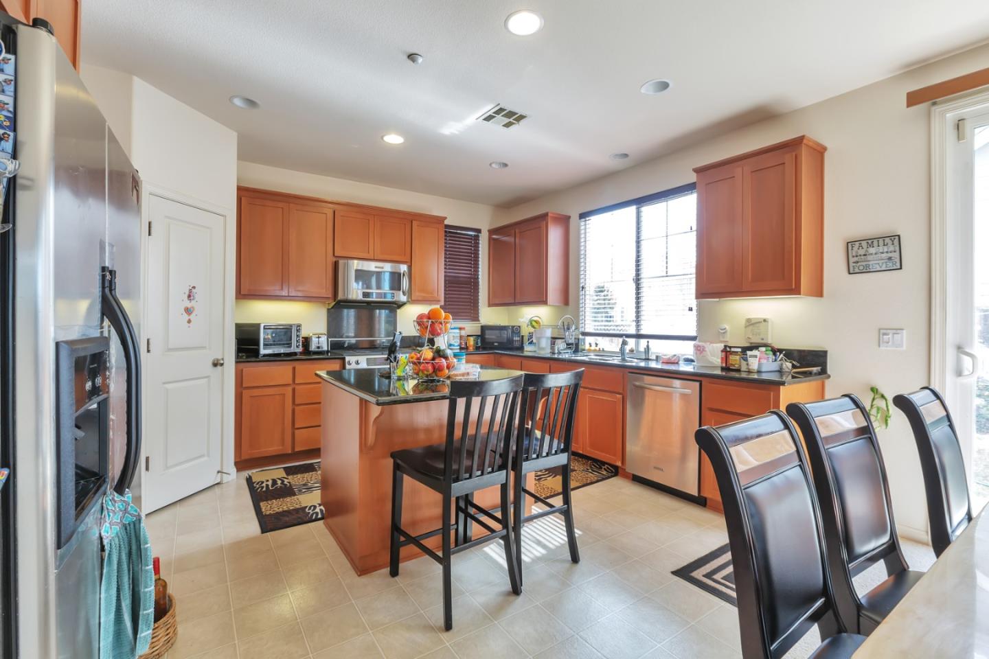 22860 Mono Street Hayward, CA 94541 - Photo 6 of 26 a kitchen with stainless steel appliances granite countertop a refrigerator a sink a stove and island