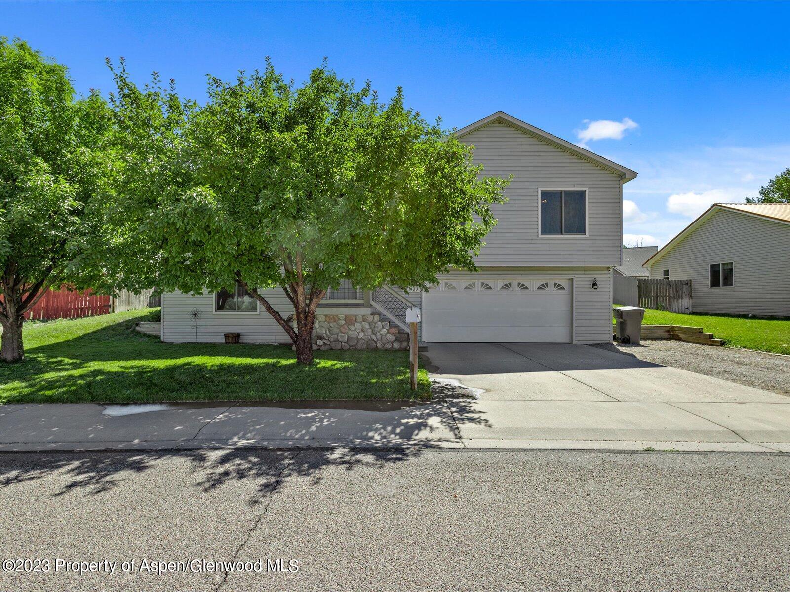 1562 Anvil View Avenue Rifle, CO 81650 - Photo 1 of 26 a front view of a house with a yard and a garage