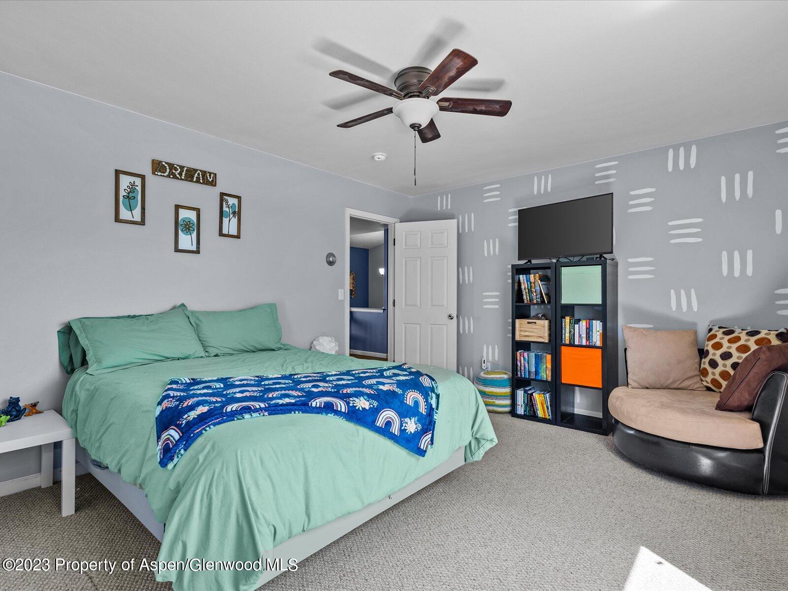 1562 Anvil View Avenue Rifle, CO 81650 - Photo 20 of 26 a bedroom with a bed and a couch