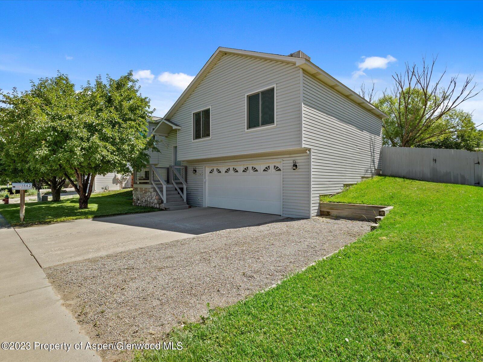 1562 Anvil View Avenue Rifle, CO 81650 - Photo 2 of 26 a front view of a house with a yard and garage