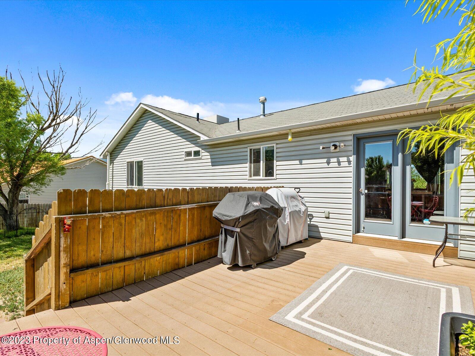 1562 Anvil View Avenue Rifle, CO 81650 - Photo 23 of 26 a view of a house with a barbeque and wooden stairs