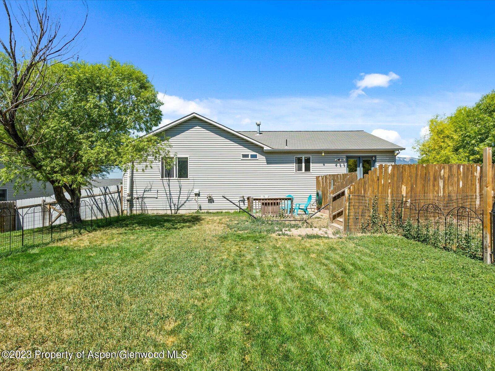 1562 Anvil View Avenue Rifle, CO 81650 - Photo 24 of 26 a view of a backyard with plants and large tree