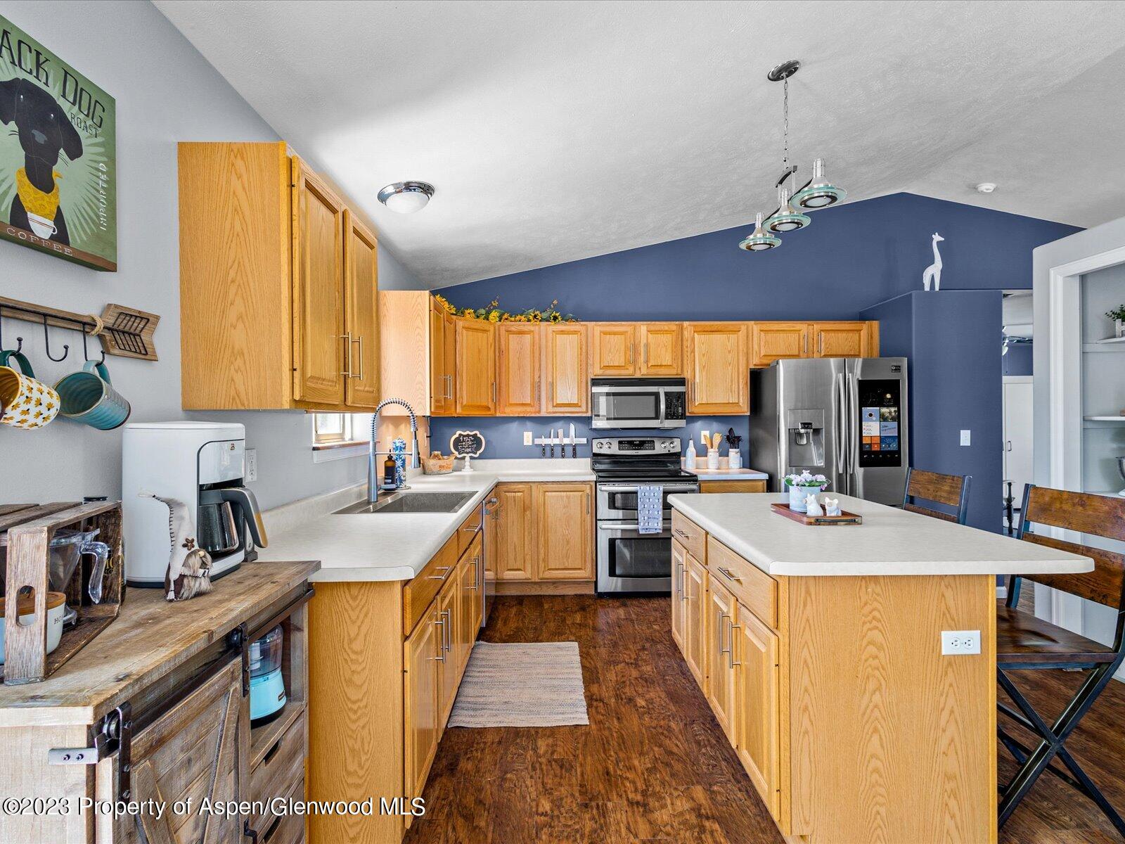 1562 Anvil View Avenue Rifle, CO 81650 - Photo 8 of 26 a kitchen with stainless steel appliances a sink stove and refrigerator