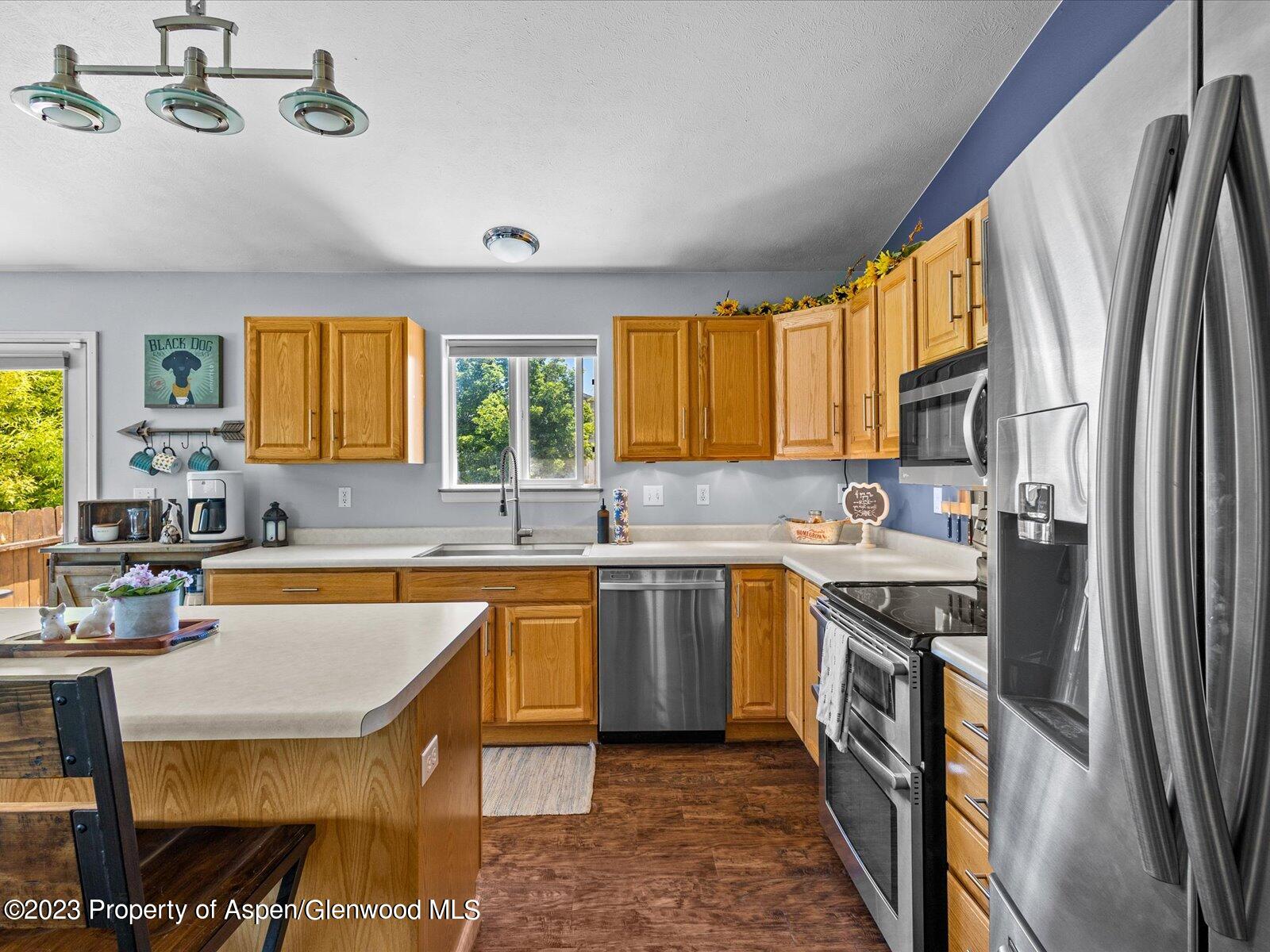 1562 Anvil View Avenue Rifle, CO 81650 - Photo 10 of 26 a kitchen with stainless steel appliances granite countertop a sink stove and refrigerator