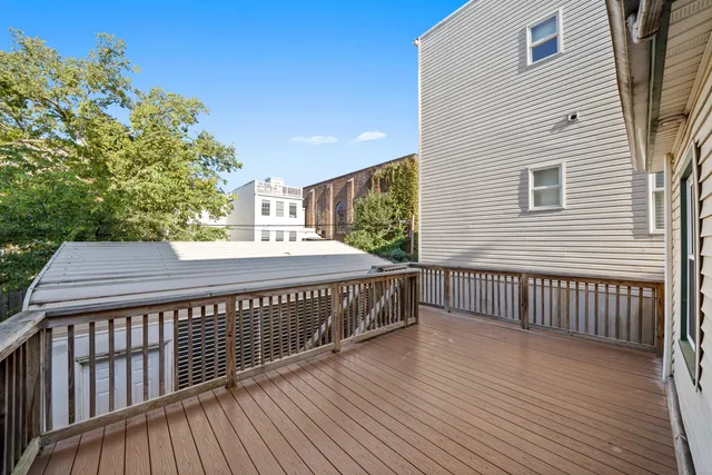 a balcony with wooden floor and fence