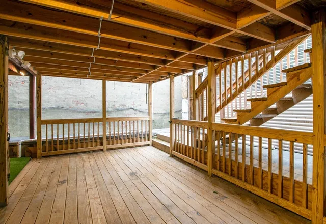 a view of porch with wooden floor
