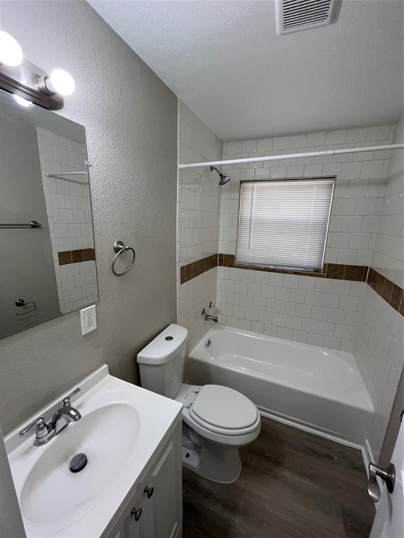 1316 North Prairie Creek Road Dallas, TX 75217 - Photo 16 of 19 Bathroom featuring a white vanity with a chrome faucet, a rectangular mirror, and a two-bulb vanity light