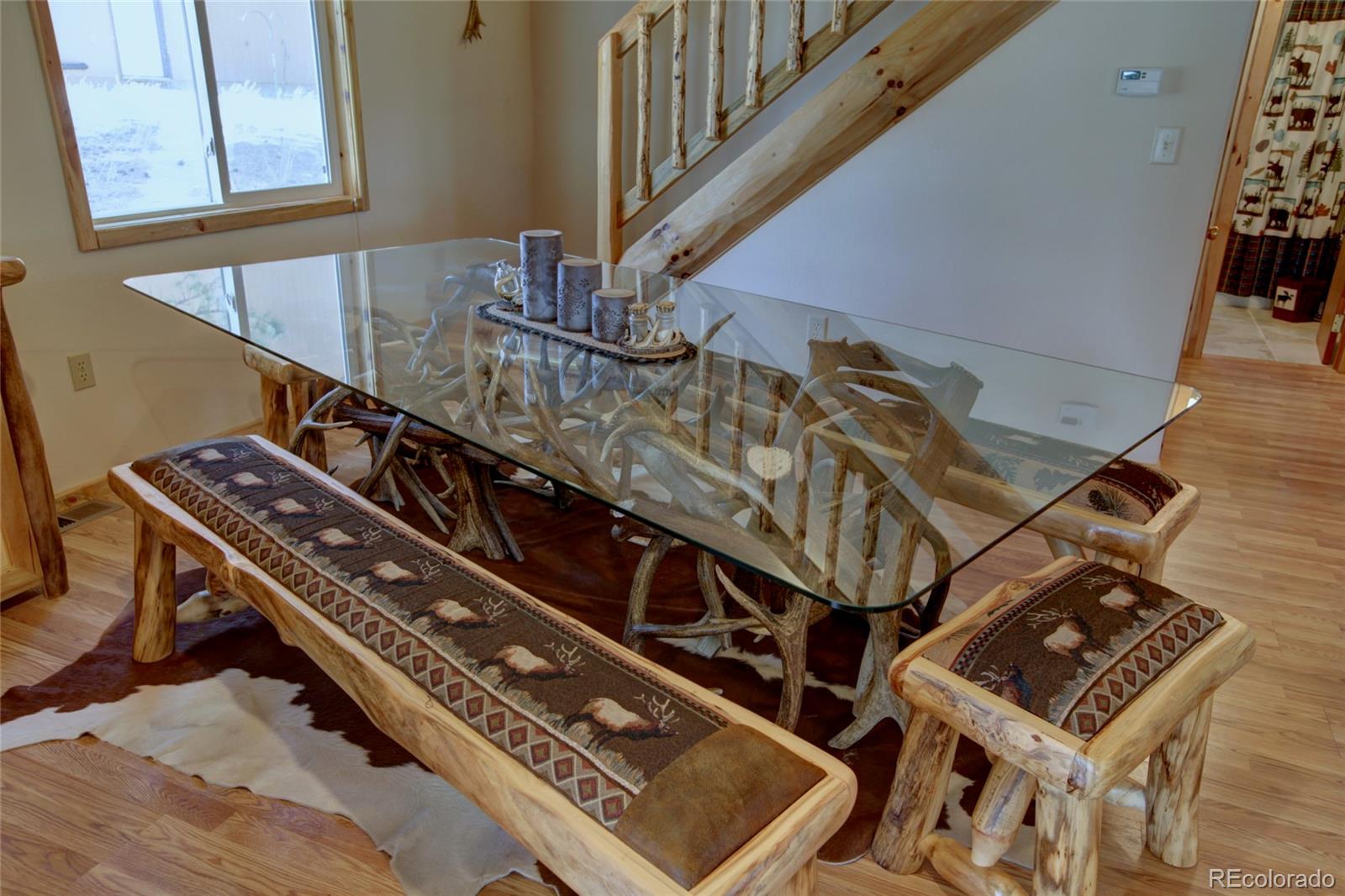 530 Red Feather Road Cotopaxi, CO 81223 - Photo 17 of 46 a view of staircase with wooden floor and lots of frames on wall