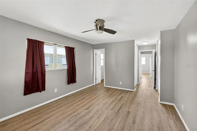 a view of a hallway with wooden floor