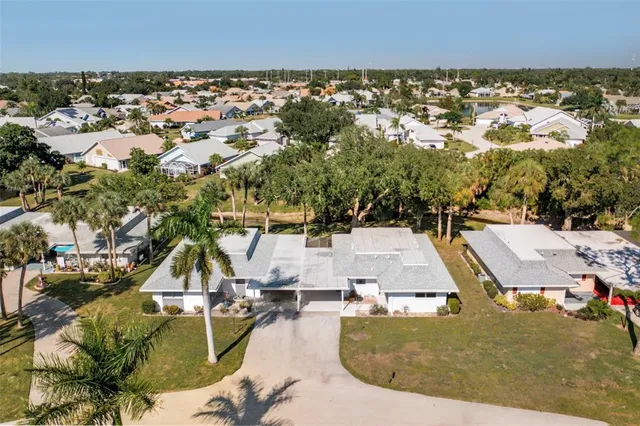 an aerial view of residential houses with outdoor space