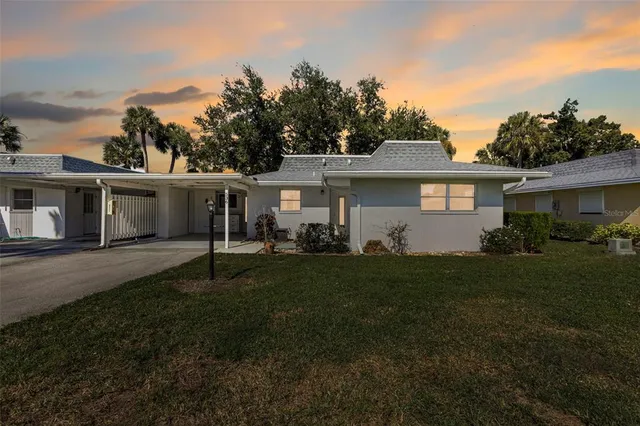 a front view of a house with yard and green space