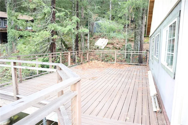 a view of a balcony with wooden floor and outdoor space
