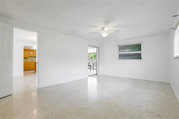 an empty room with windows and closet