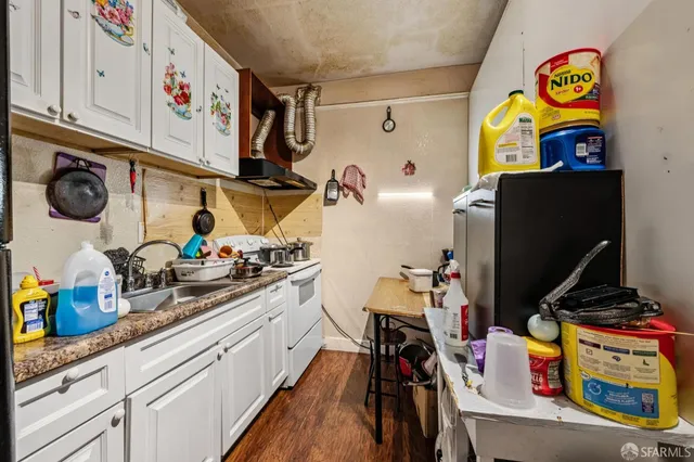 a kitchen with stainless steel appliances a sink and cabinets