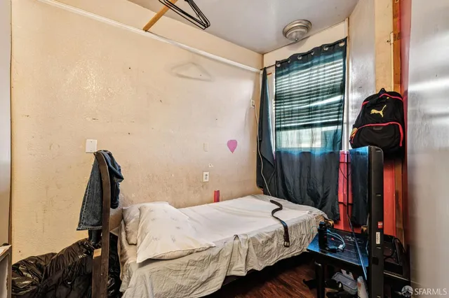 a bedroom with a bed and a window