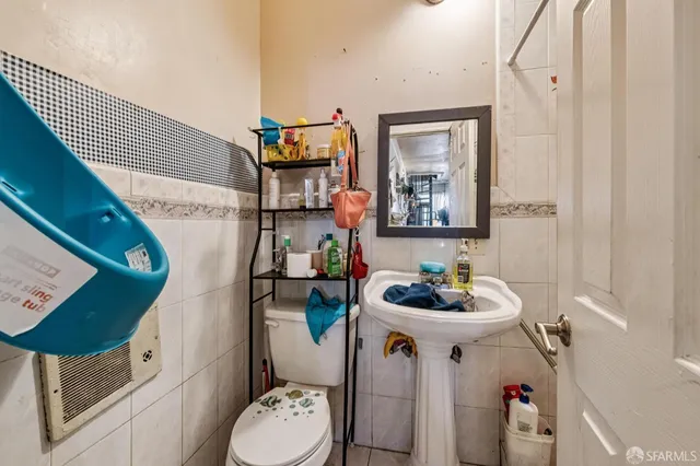 a bathroom with a sink toilet and mirror