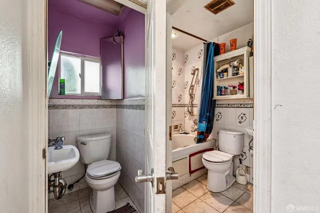 a white toilet sitting next to a bathroom sink