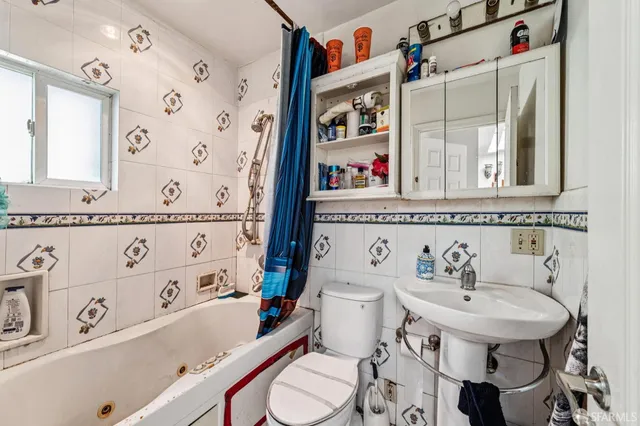 a bathroom with a sink a toilet and a bathtub