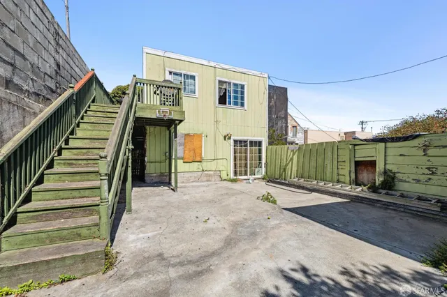 a view of a house with stairs and a street
