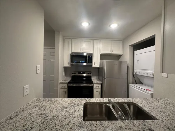 a kitchen with a refrigerator sink and microwave