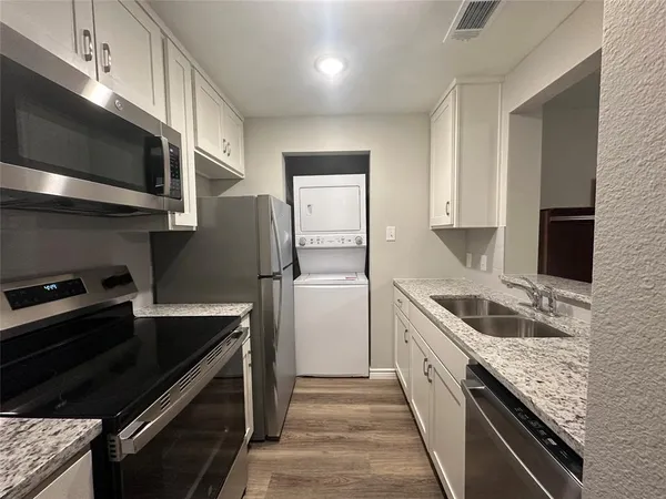 a kitchen with a sink stove and microwave