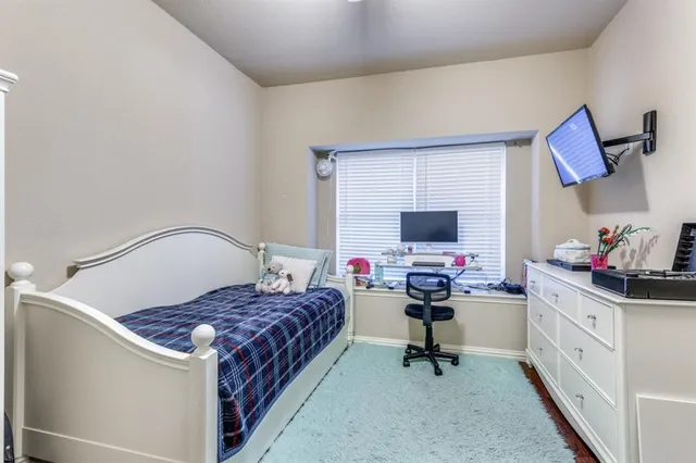 a bedroom with a bed and flat screen tv