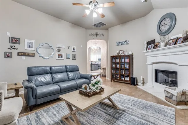 a living room with furniture a clock and a fireplace