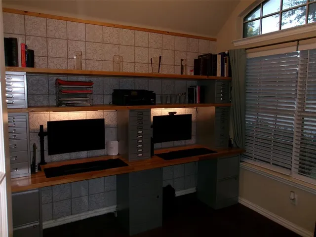 a view of a livingroom with workspace and a window