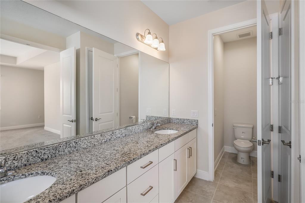 19803 Bridgetown Loop Venice, FL 34293 - Photo 20 of 51 a bathroom with a granite countertop sink and a mirror