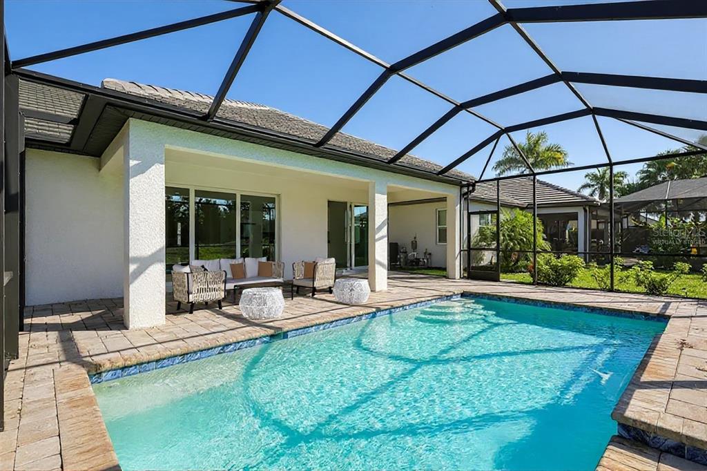 19803 Bridgetown Loop Venice, FL 34293 - Photo 2 of 51 a view of a backyard with a patio and fire pit