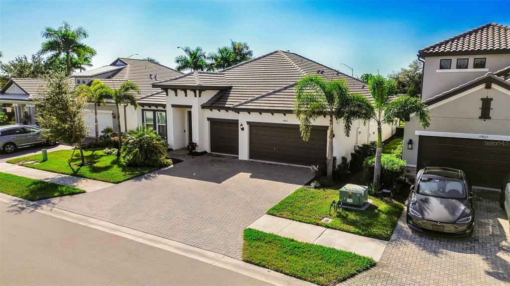 19803 Bridgetown Loop Venice, FL 34293 - Photo 31 of 51 a front view of a house with a garden and potted plants