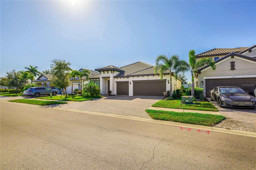 19803 Bridgetown Loop Venice, FL 34293 - Photo 41 of 51 a front view of a house with a garden and outdoor seating