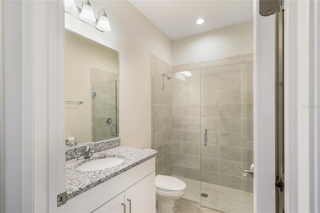 19803 Bridgetown Loop Venice, FL 34293 - Photo 42 of 51 a bathroom with a granite countertop sink a toilet and shower