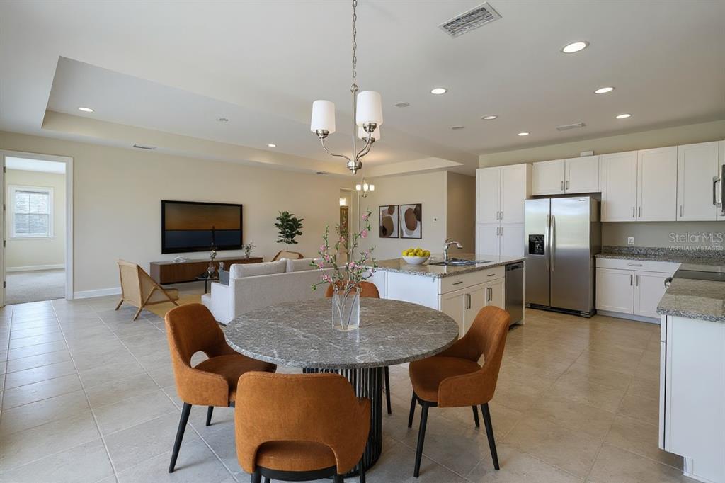 19803 Bridgetown Loop Venice, FL 34293 - Photo 5 of 51 a dining room with furniture a window and kitchen view