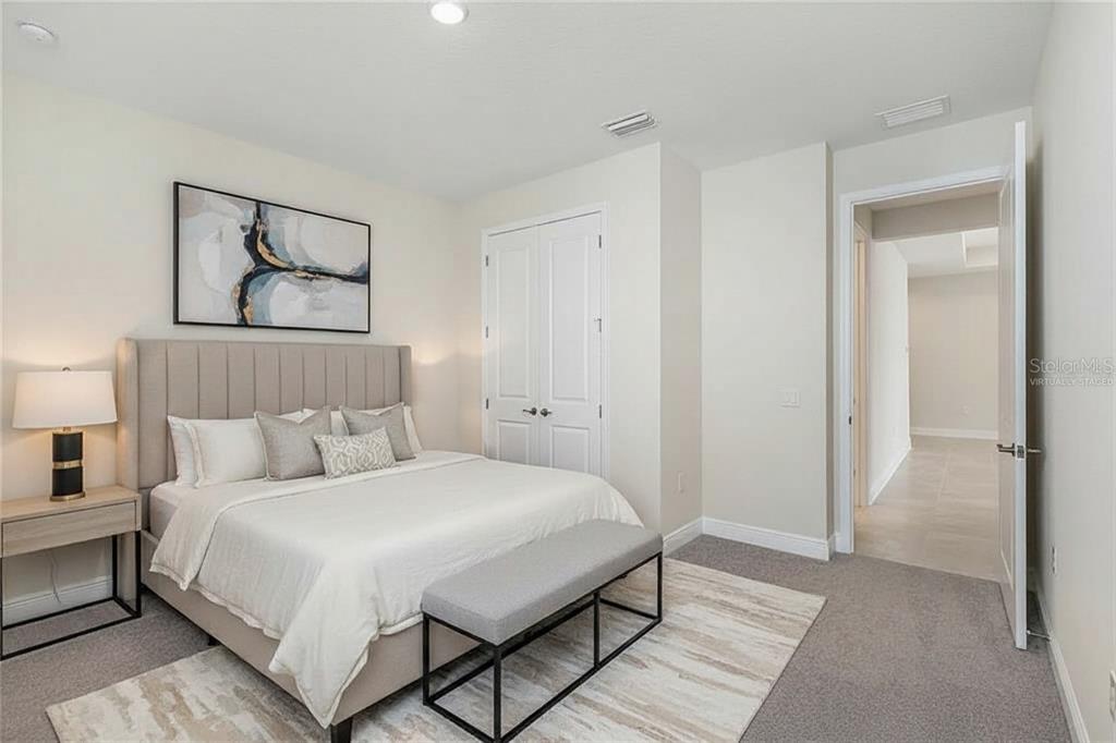 19803 Bridgetown Loop Venice, FL 34293 - Photo 9 of 51 a bedroom with a bed and a painting on the wall