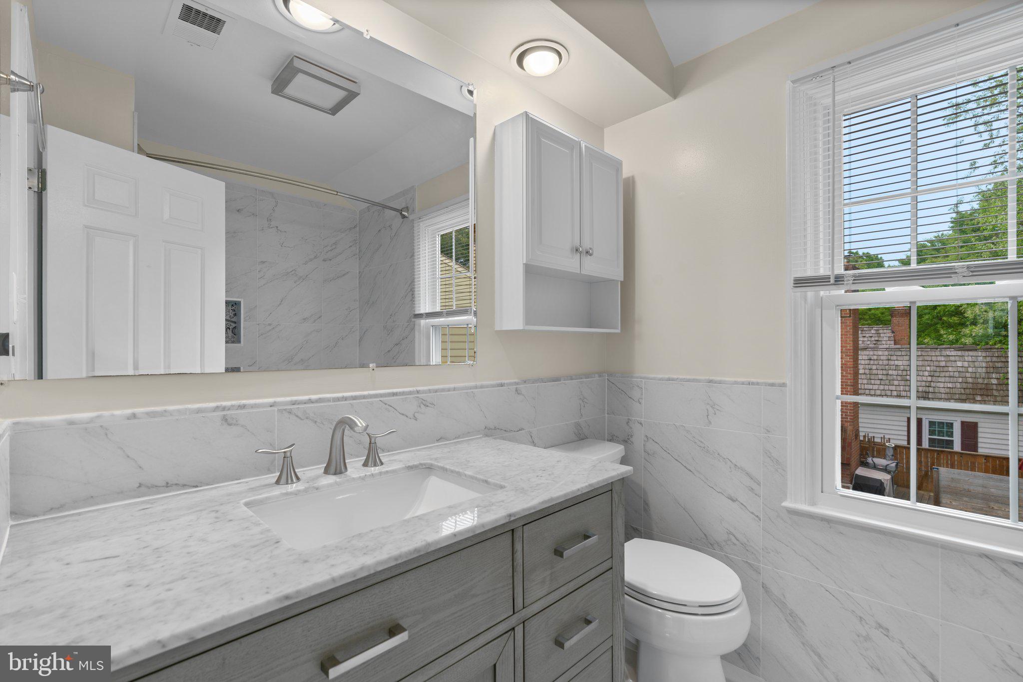 2 Oxley Square Road Gaithersburg, MD 20877 - Photo 23 of 49 a bathroom with a granite countertop sink a toilet and a window