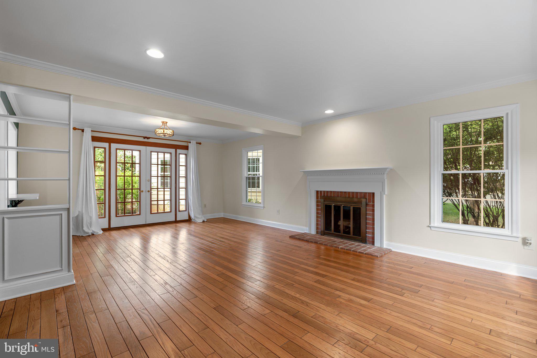 2 Oxley Square Road Gaithersburg, MD 20877 - Photo 4 of 49 a view of an empty room with wooden floor fireplace and a window