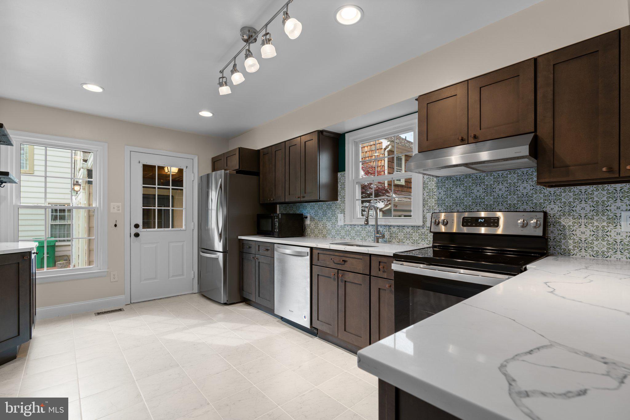 2 Oxley Square Road Gaithersburg, MD 20877 - Photo 10 of 49 a kitchen with stainless steel appliances granite countertop a sink stove and refrigerator
