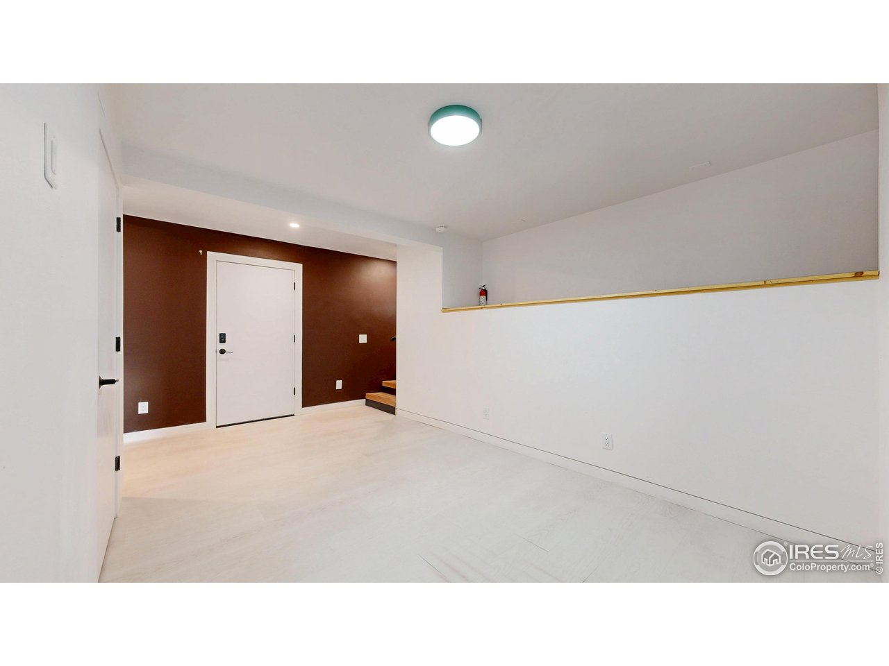 710 Tanager Road Estes Park, CO 80517 - Photo 26 of 43 Downstairs Family / Rec Room with a door to the utility room.