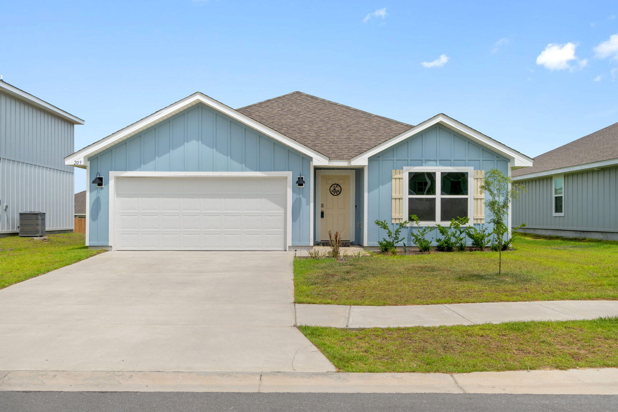 209 Laurel Hill Street Crestview, FL 32539 - Photo 1 of 43 a front view of a house with a yard and garage
