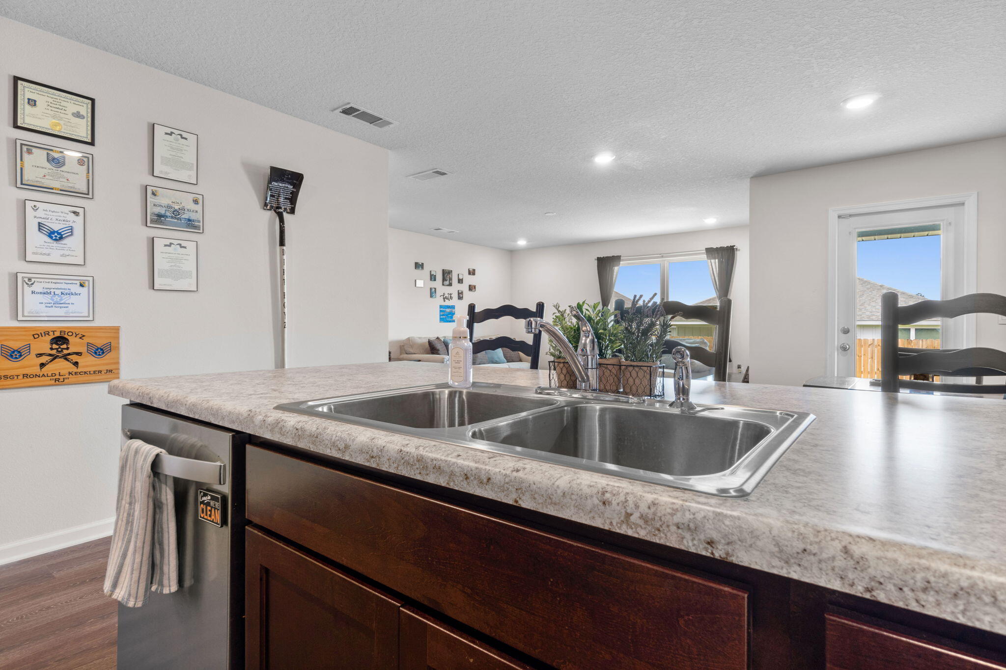 209 Laurel Hill Street Crestview, FL 32539 - Photo 11 of 43 a kitchen with granite countertop a sink and a wooden floor