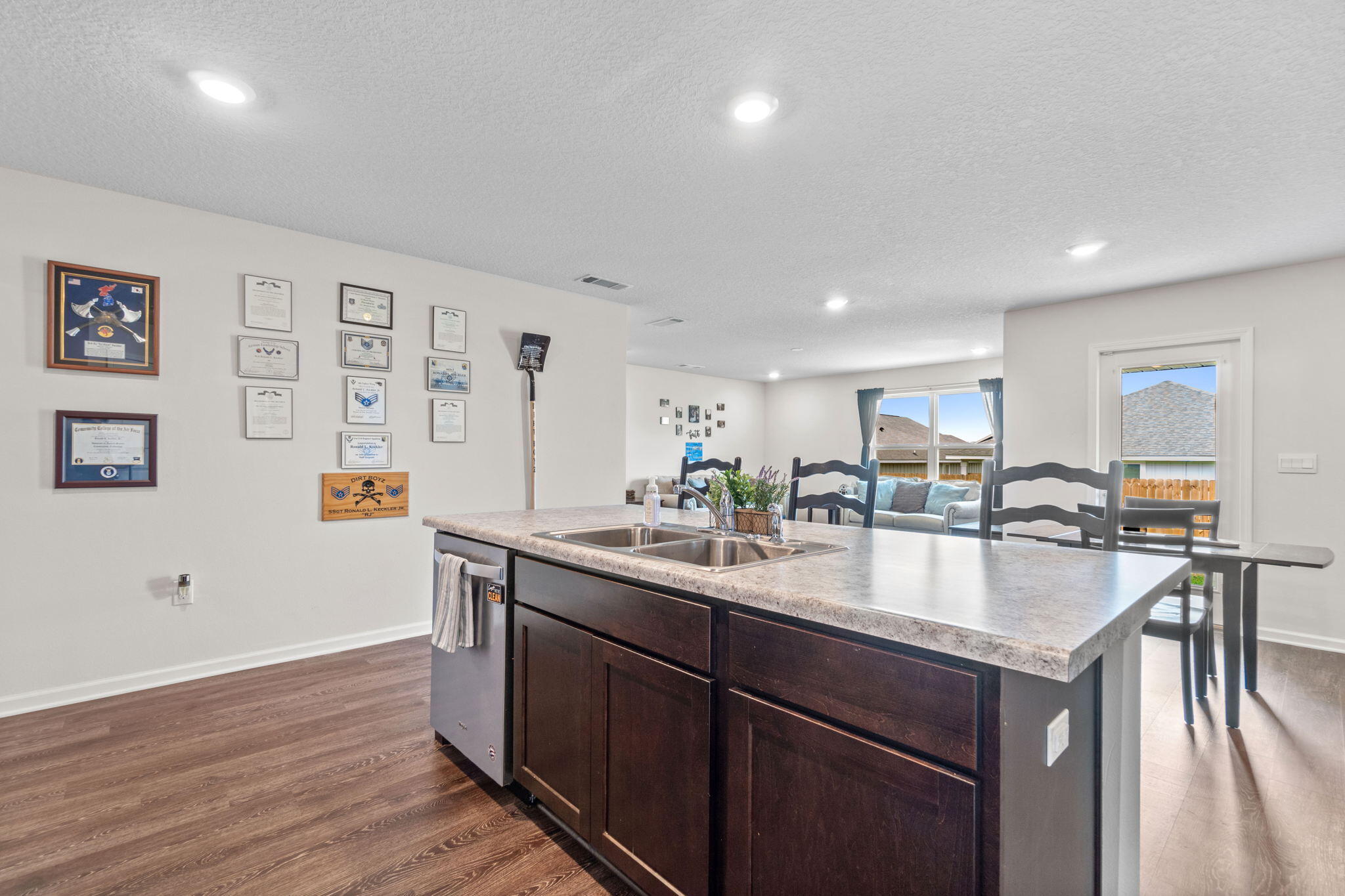 209 Laurel Hill Street Crestview, FL 32539 - Photo 12 of 43 a large kitchen with stainless steel appliances granite countertop a lot of counter space and wooden floor