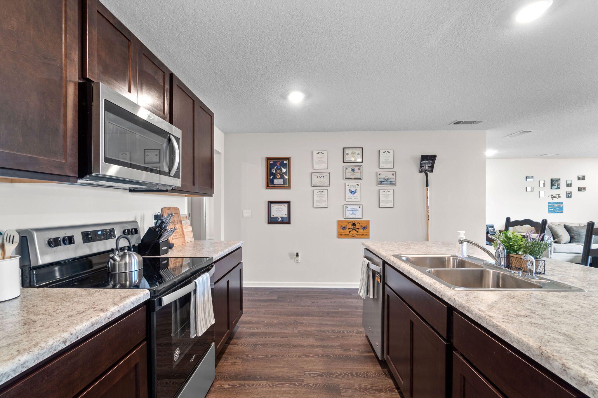 209 Laurel Hill Street Crestview, FL 32539 - Photo 13 of 43 a kitchen with stainless steel appliances granite countertop a sink stove and refrigerator