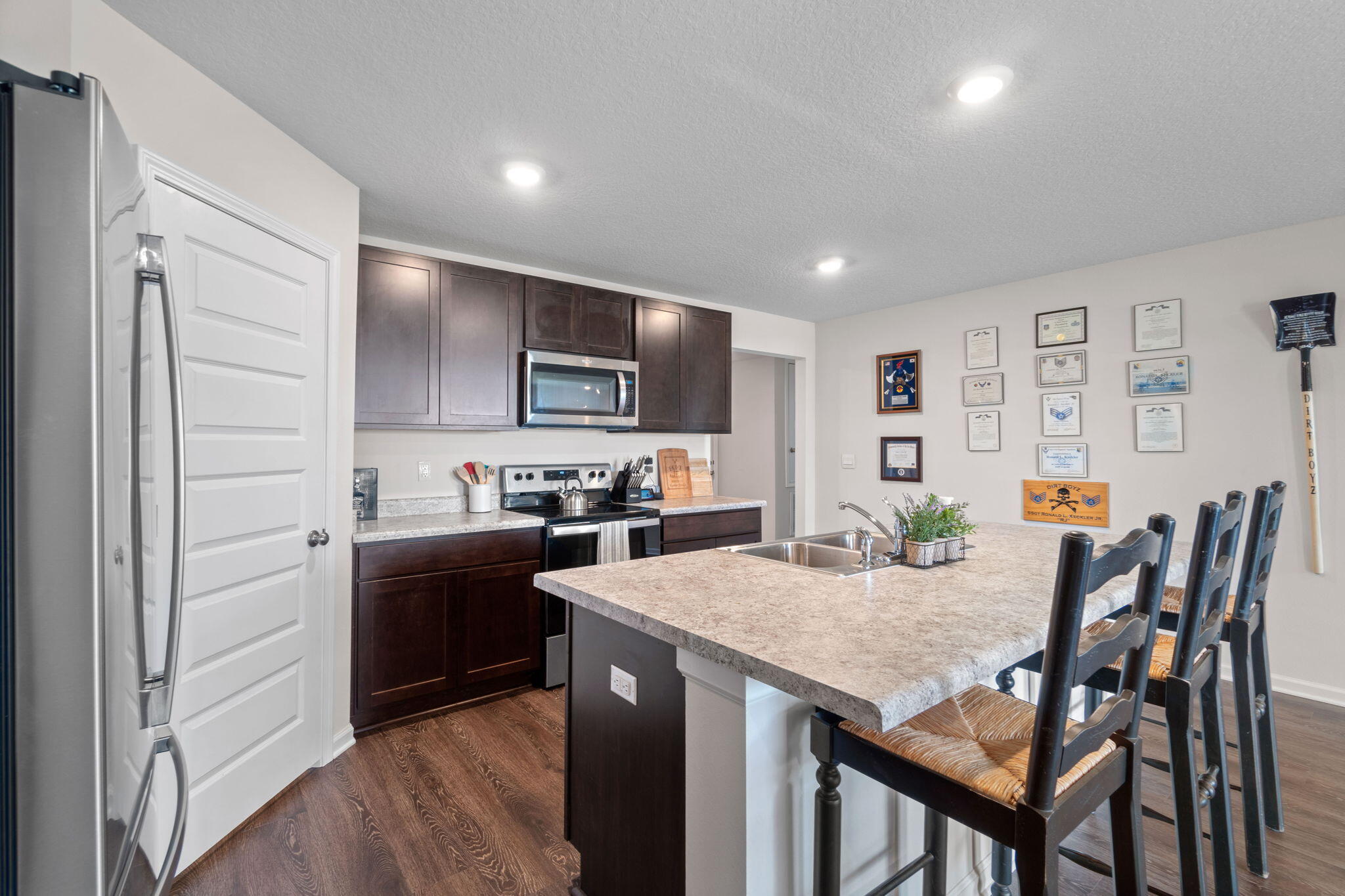 209 Laurel Hill Street Crestview, FL 32539 - Photo 14 of 43 a kitchen with kitchen island cabinets and refrigerator